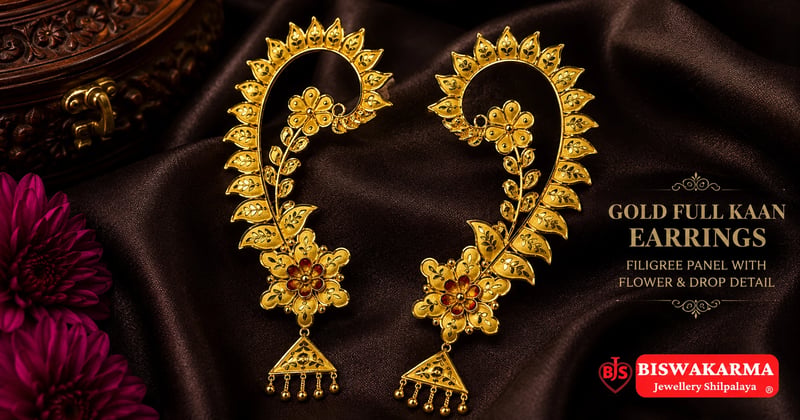 Gold full kaan earrings with filigree panel and jhumka drop on a dark cloth