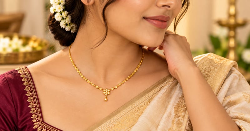 Collarbone-length gold pendant necklace styled with a saree blouse