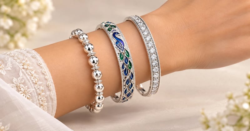Silver bangles design for women: bead churi, peacock enamel and green stone-set bangle on a wrist